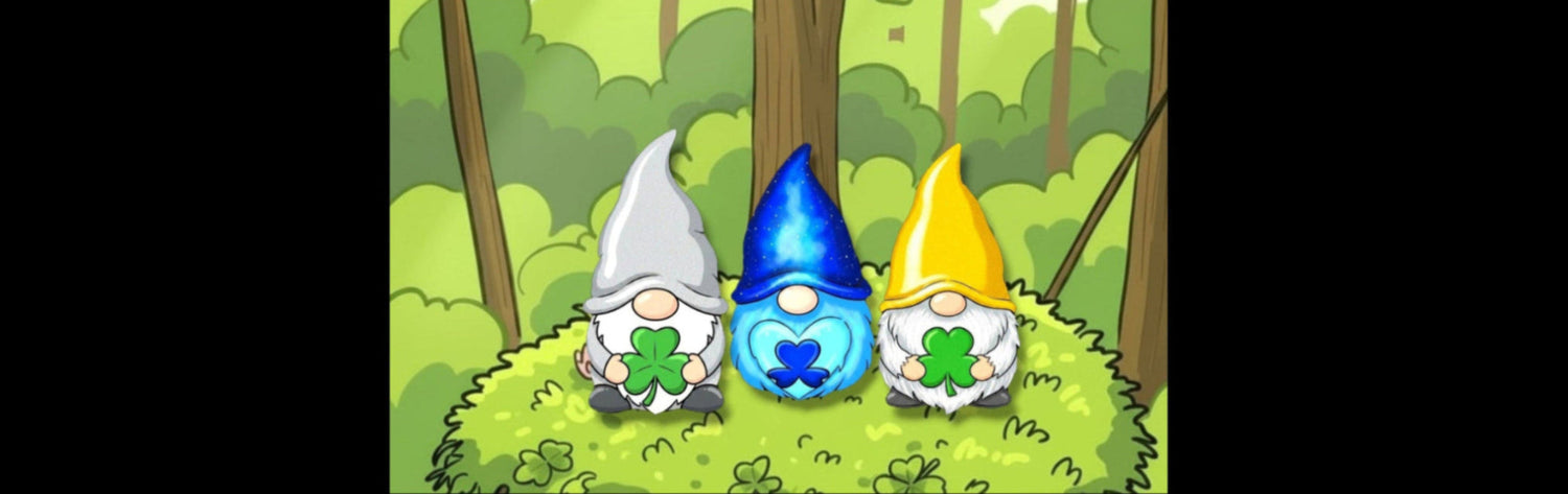 Three cartoon garden gnomes sitting on a grassy hill in a forest. The gnomes have white beards, pointed hats in silver, blue, and yellow, and each holds a green four-leaf clover.